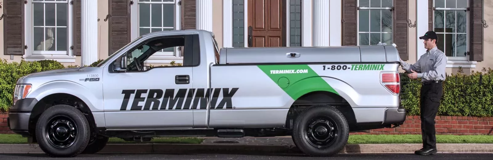 Terminix technician in front of home
